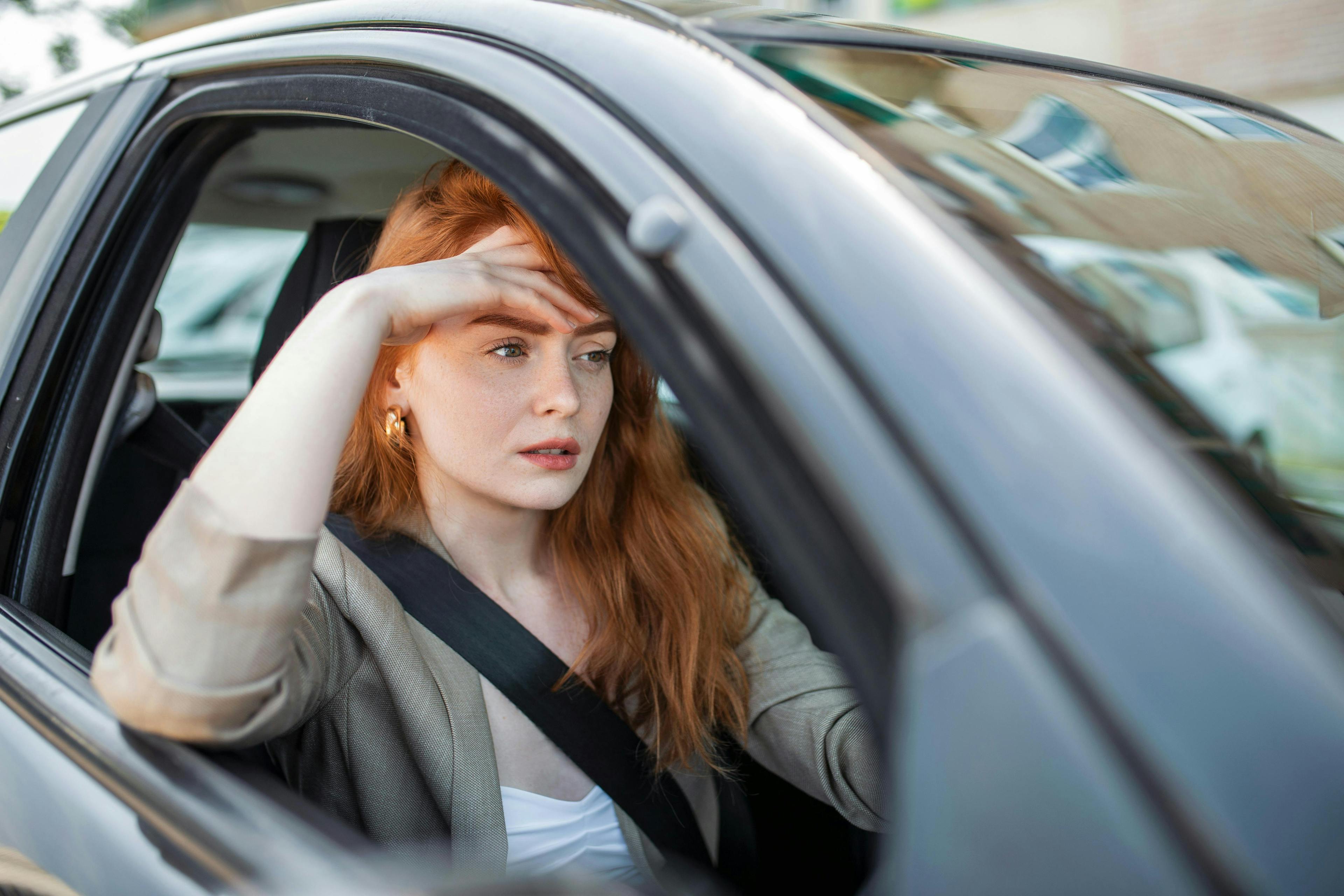 Nervous driver sits behind the wheel of a car