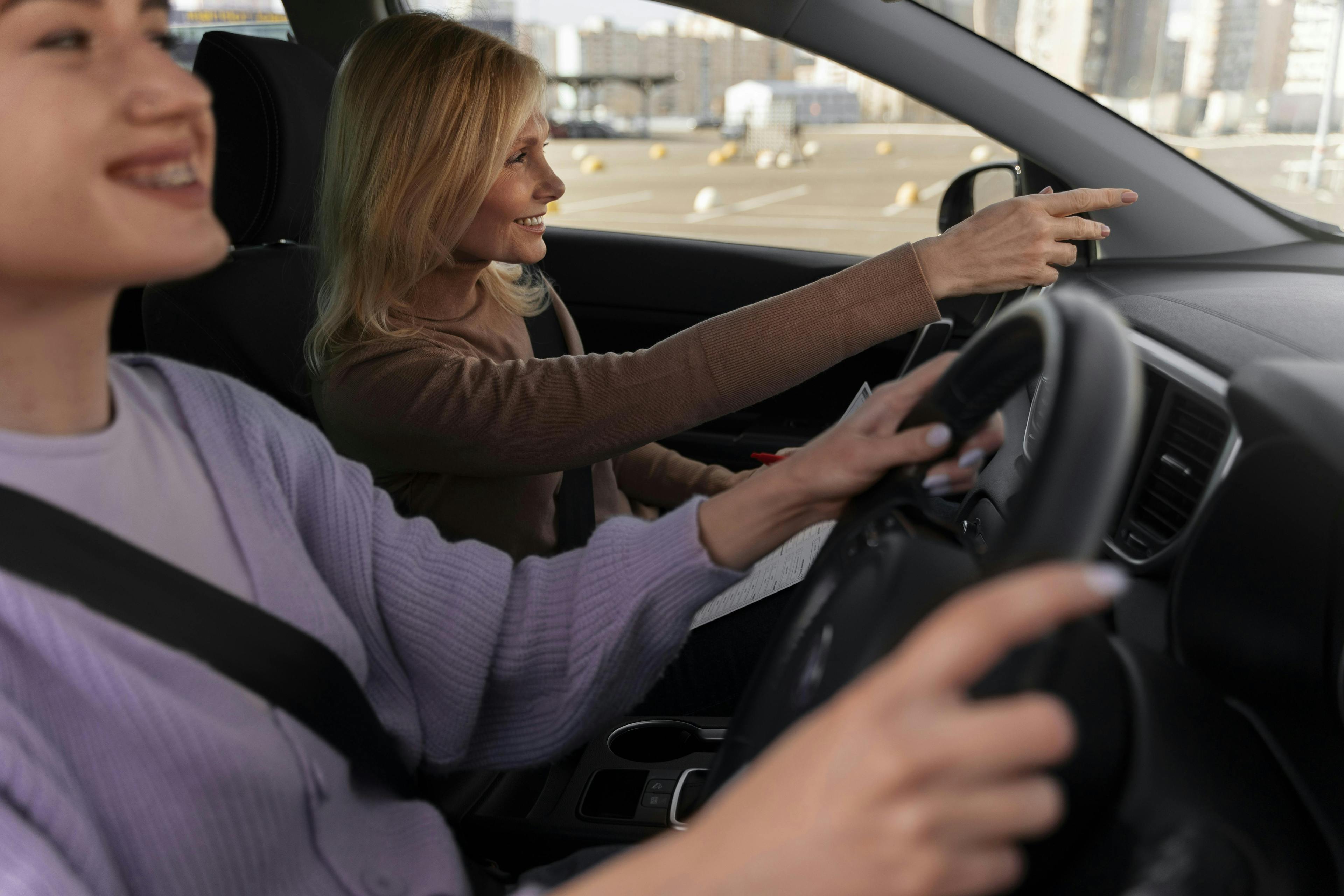 Woman being directed by her driving instructor as she does a driving lesson